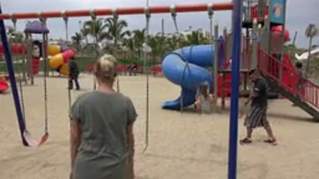 SAN JOSE DEL CABO MEXICO-2019: A Mother Pushing Her Young White Daughter On A Swing