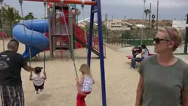 SAN JOSE DEL CABO MEXICO-2019: Children At Playground With Parents Dad Pushing