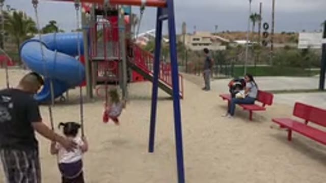 SAN JOSE DEL CABO MEXICO-2019: Dad Pushing Daughter On A Swing