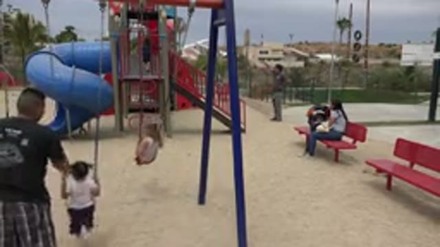 SAN JOSE DEL CABO MEXICO-2019: Kids Playing Swing With Dad On The Playground