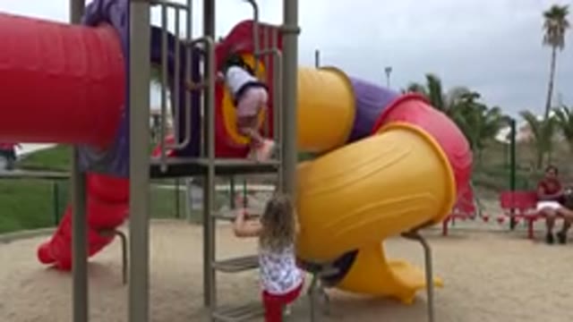 SAN JOSE DEL CABO MEXICO-2019: Two Little Girls Climb Into A Playground To Go