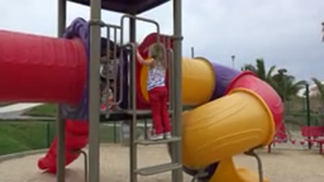SAN JOSE DEL CABO MEXICO-2019: A Little Blonde Girl Playing In A Public Park In