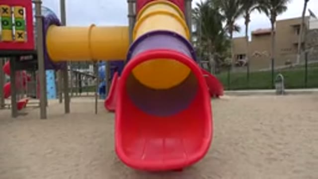 SAN JOSE DEL CABO MEXICO-2019: View Of Red Yellow And Blue Slide At Playground
