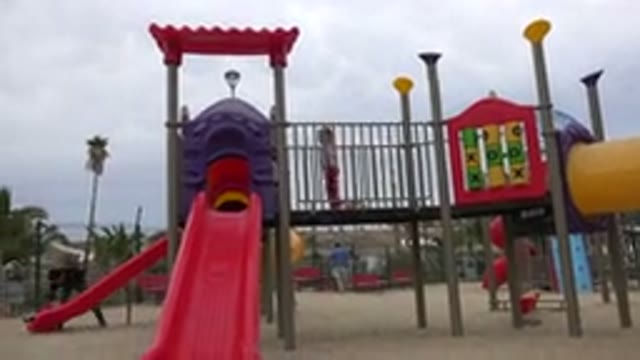 SAN JOSE DEL CABO MEXICO-2019: Two Little Girls Prepare To Go Down Plastic Slide
