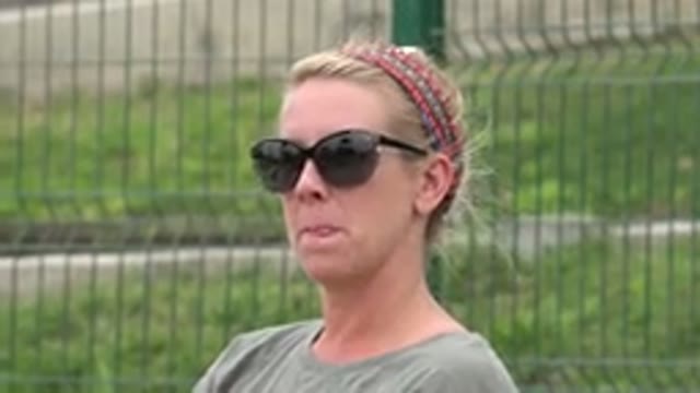 SAN JOSE DEL CABO MEXICO-2019: Sunglasses Woman Smiling in Park Near Fence