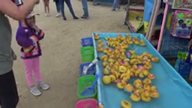 SAN JOSE DEL CABO MEXICO-2019: Parent And Child Playing A Carnival Game