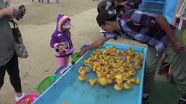 SAN JOSE DEL CABO MEXICO-2019: Young Girl Playing a Fair Game Fishing Ducks Out