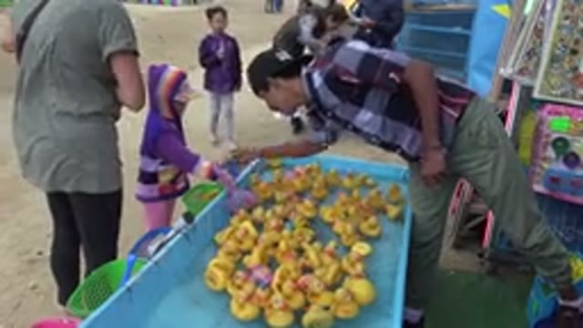 SAN JOSE DEL CABO MEXICO-2019: Shopkeeper Inspects Plastic Ducks At A Marketplace