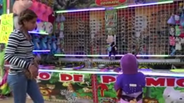 SAN JOSE DEL CABO MEXICO-2019: Woman, Kid, and Girls at Fair Winning Prize with Peluches