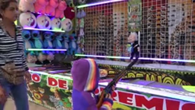SAN JOSE DEL CABO MEXICO-2019: Girl Playing A Shooting Game At The Carnival For