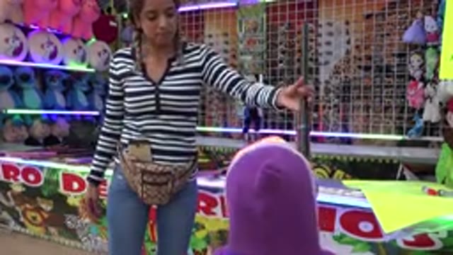 SAN JOSE DEL CABO MEXICO-2019: A Carnival Worker Hands The Special Rifle To A Child