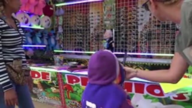 SAN JOSE DEL CABO MEXICO-2019: Child Uses Air Rifle At Fair To Try To Win