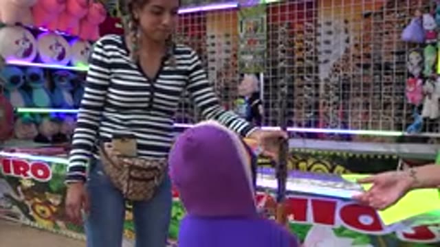 SAN JOSE DEL CABO MEXICO-2019: A Little Girl Readies to Play a Carnival Game