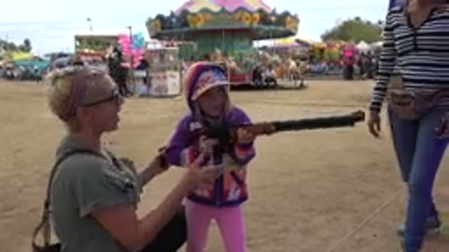 SAN JOSE DEL CABO MEXICO-2019: Little Girl Successfully Shoots Target at Fair Game