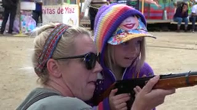 SAN JOSE DEL CABO MEXICO-2019: Woman Showing Her Small Daughter How To Aim And