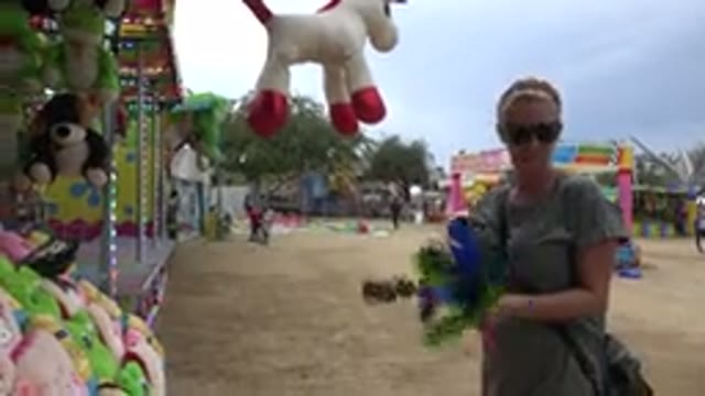 SAN JOSE DEL CABO MEXICO-2019: Women At Amusement Park Throwing Feathered Darts