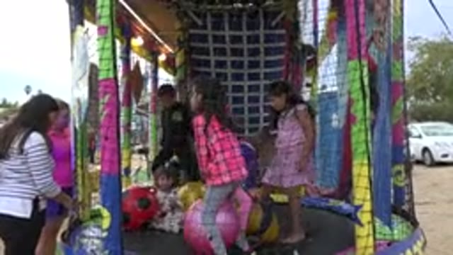 SAN JOSE DEL CABO MEXICO-2019: Kids Playing On A Trampoline Mothers Standing Out