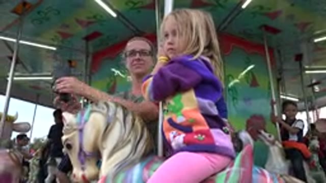 SAN JOSE DEL CABO MEXICO-2019: Young Child Riding A Machine During A Fair While