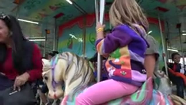 SAN JOSE DEL CABO MEXICO-2019: Mother And Daughter On Merry-Go-Round Preparing