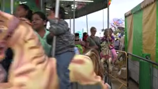 SAN JOSE DEL CABO MEXICO-2019: Children Riding Horses On A Carousel With Their Parents