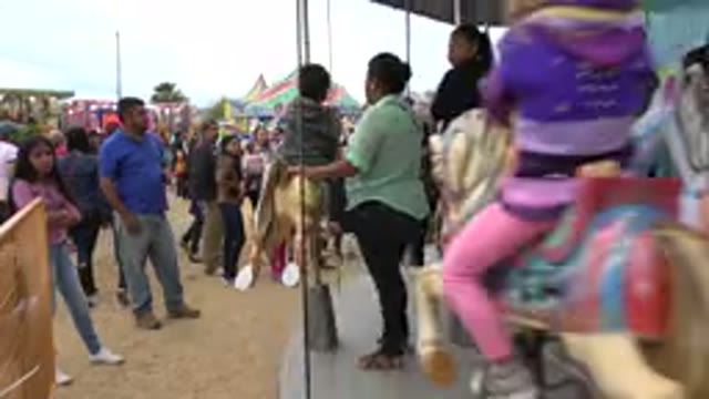 SAN JOSE DEL CABO MEXICO-2019: Parents Ride With Children On Carousel While