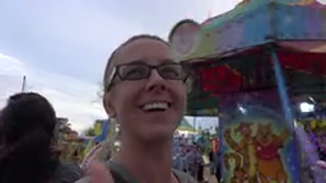 SAN JOSE DEL CABO MEXICO-2019: Woman Talks To Camera Person As Kiddie Amusement Park Ride Spins