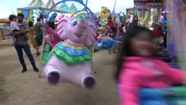 SAN JOSE DEL CABO MEXICO-2019: High Five To Kids Riding A Ride At A Carnival