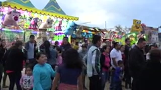 SAN JOSE DEL CABO MEXICO-2019: Crowd Gather Around Busy Carnival Ride
