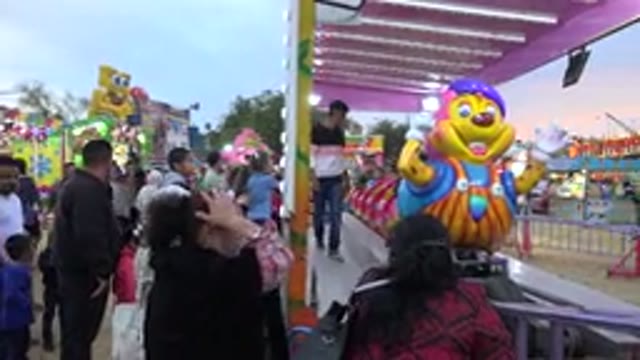 SAN JOSE DEL CABO MEXICO-2019: Male Worker Starting A Kids Ride At The Bright