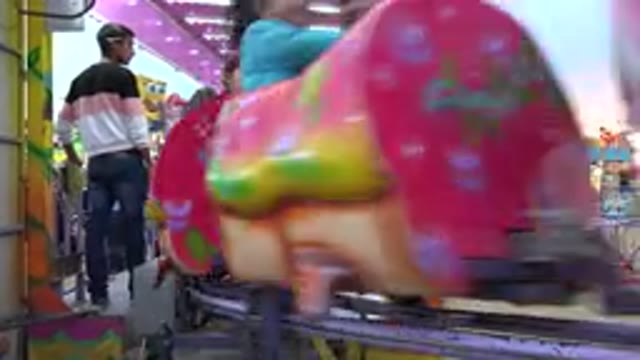 SAN JOSE DEL CABO MEXICO-2019: Carnival Worker Watches As The Young And Old