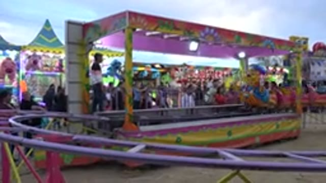 SAN JOSE DEL CABO MEXICO-2019: Children Ride Past Camera On Small Colorful Caterpillar Ride