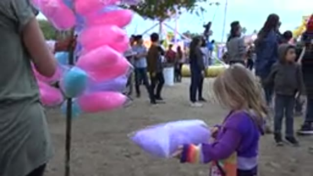 SAN JOSE DEL CABO MEXICO-2019: Little Girl Stares at Cotton Candy at Fair