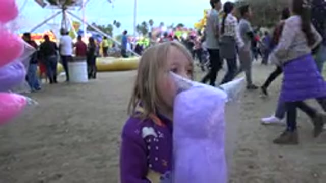 SAN JOSE DEL CABO MEXICO-2019: Girls Trying To Eat Some Cotton Candy At A Carnival