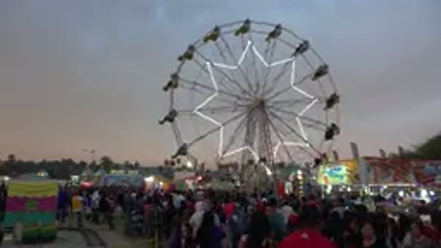 SAN JOSE DEL CABO MEXICO-2019: Ferris Wheel Spins Over Large Crowd At Sundown