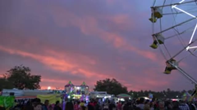 SAN JOSE DEL CABO MEXICO-2019: Ferris Wheel Starting Up In A Crowded Fairground