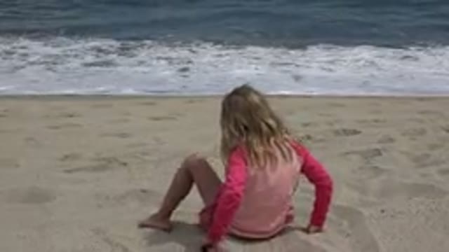 SAN JOSE DEL CABO MEXICO-2019: Small Child Playing Sliding on Sand Near Beach
