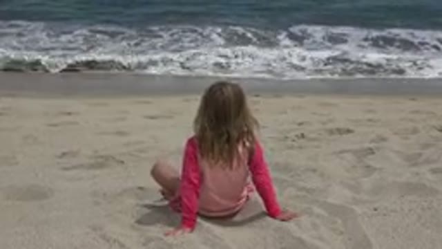 SAN JOSE DEL CABO MEXICO-2019: Small Child Watches Waves Gently Come On Shore At