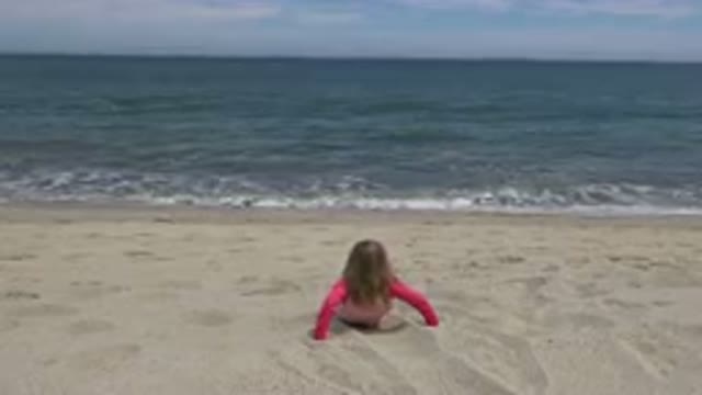 SAN JOSE DEL CABO MEXICO-2019: Small Child Sitting On Sand In Front Of Surf