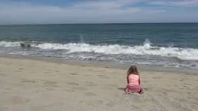 SAN JOSE DEL CABO MEXICO-2019: Little Girl Sitting On Beach Watching Ocean Waves