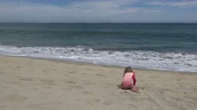 SAN JOSE DEL CABO MEXICO-2019: A Little Girl Dressed in Pink Plays with the Sand