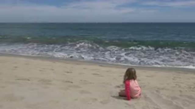 SAN JOSE DEL CABO MEXICO-2019: Child Sitting On The Sand Of A Beach With The