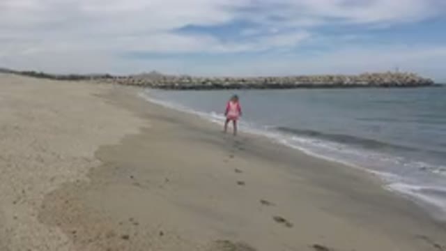 SAN JOSE DEL CABO MEXICO-2019: Girl Explores Ocean Waves From A Safe Distance To