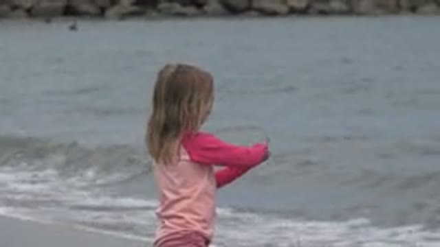 SAN JOSE DEL CABO MEXICO-2019: A Baby Girl Playing With Sand Beside The Sea