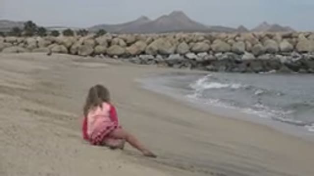 SAN JOSE DEL CABO MEXICO-2019: Little Girl Drawn Closer To The Water's Edge With