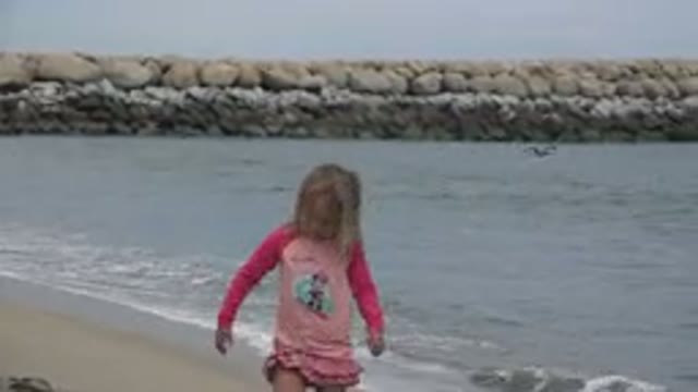 SAN JOSE DEL CABO MEXICO-2019: Child Plays With Her Feet In The Sand As She Has