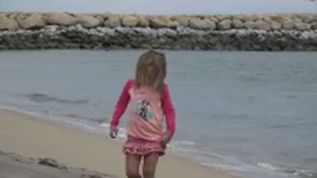 SAN JOSE DEL CABO MEXICO-2019: Young Girl Walking Along Sea Shore In A Pink Frilly Dress