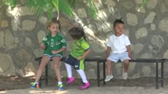 SAN JOSE DEL CABO MEXICO-2019: Girl Wearing Green Shirt With Blue Shorts Rises