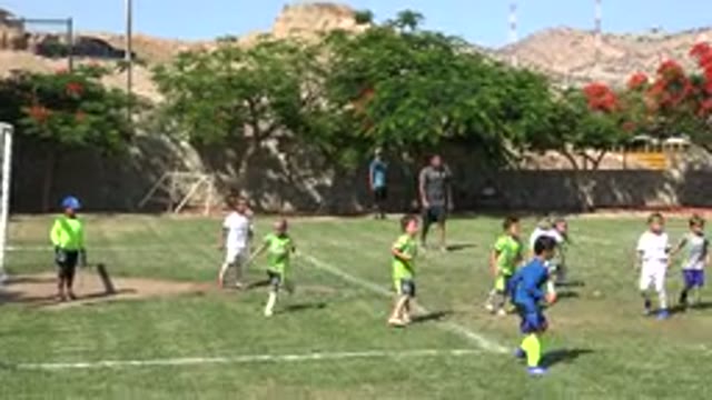 SAN JOSE DEL CABO MEXICO-2019: Children Playing Soccer On A Sunny Day While Adults Watch