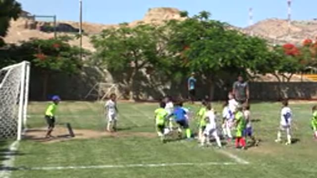 SAN JOSE DEL CABO MEXICO-2019: Child Wearing White Shorts Kicks Ball Past Kid