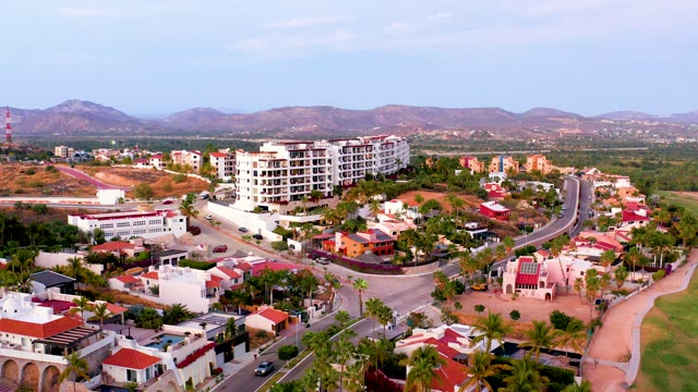 SAN JOSE DEL CABO MEXICO-2021: Residential Neighborhood with Moving Car and Mountain Backdrop
